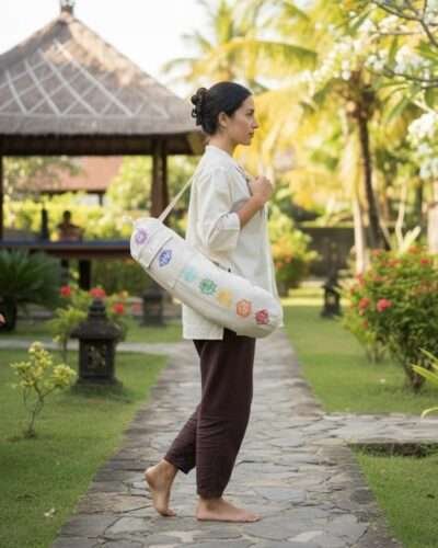 a woman carrying hemp yoga mat cover from the side in a retreat centre