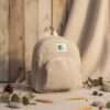 a mini beige hemp backpack on a table