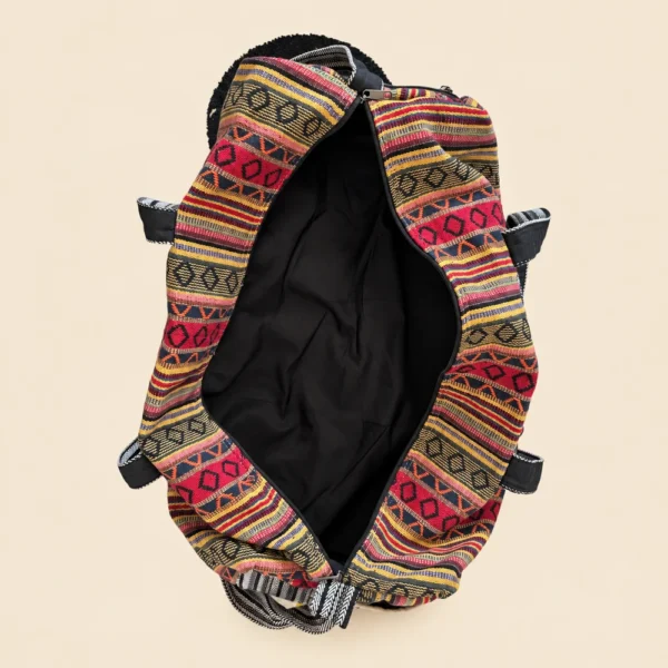 Inside of Colorful and Vibrant Duffle Bag showing woven textile texture, side pocket and strap hardware
