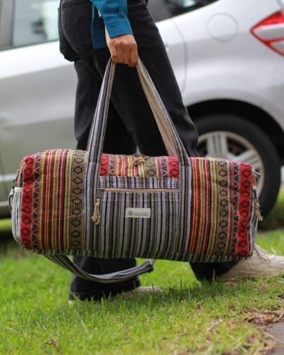 Colorful Vibrant large duffle bag carrying by a womanoutdoor setting