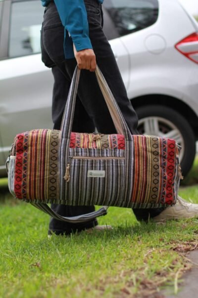 Colorful Vibrant large duffle bag carrying by a womanoutdoor setting