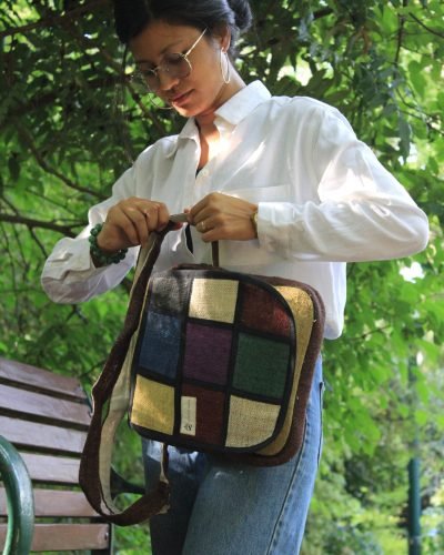women tightening strap of vibrant hemp side bag