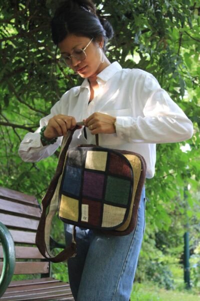 women tightening strap of vibrant hemp side bag
