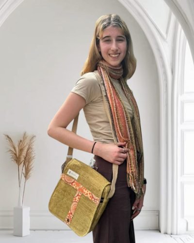 model wearing a Tribal Harmony cross body bag, mustard color, Hand-made in Nepal