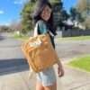 A woman carrying Mustard color backpack