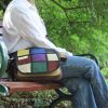 a person sitting with vibrant hemp bag on a bench at a park
