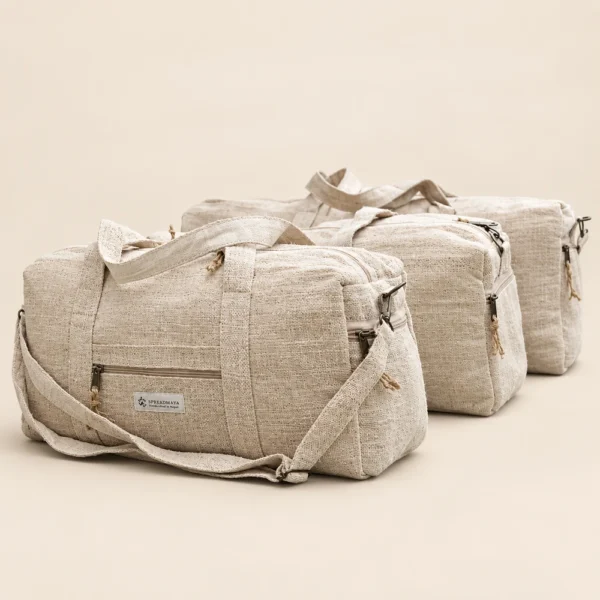 three natural hemp duffle bags arranged on a plain beige background