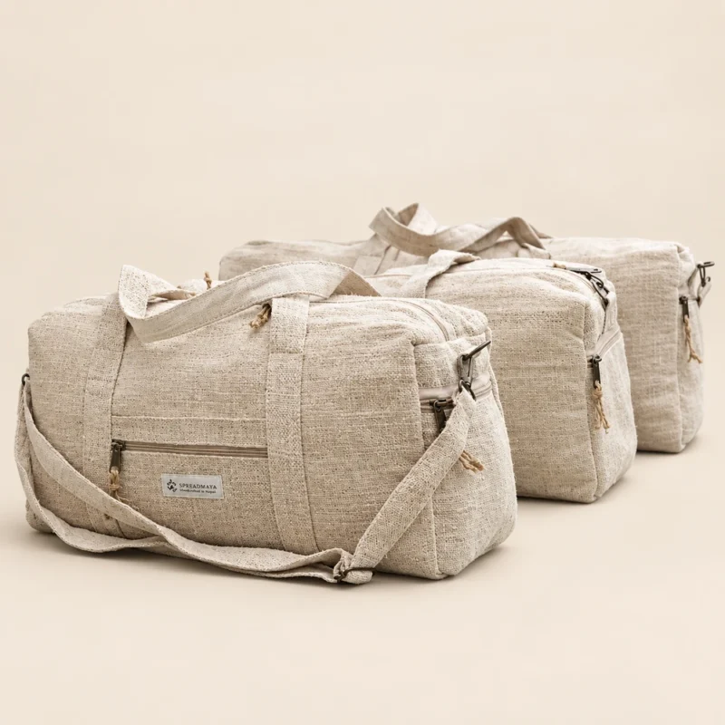 three natural hemp duffle bags arranged on a plain beige background