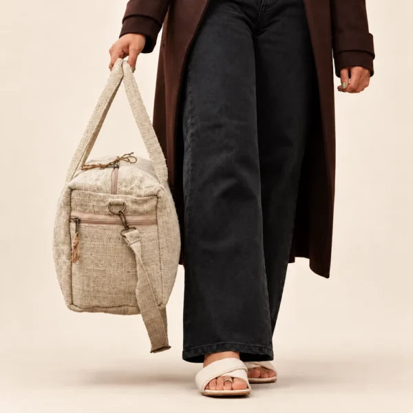 woman carrying a natural hemp duffle bag with a detachable shoulder strap