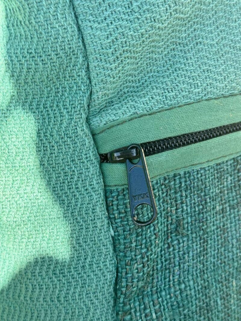 zoomed view of roll top large hemp backpack zipper