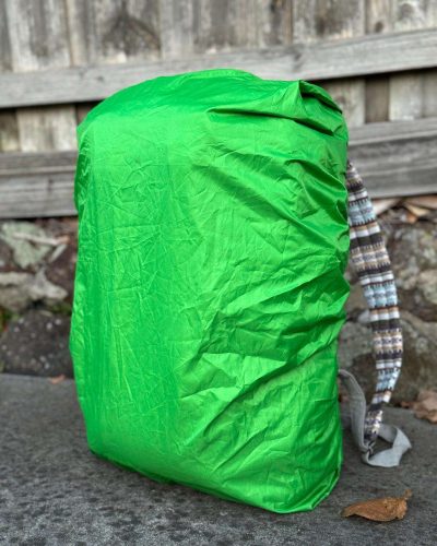hemp travel backpack covered in green raincover