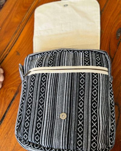 opened flap of black and white hemp side bag