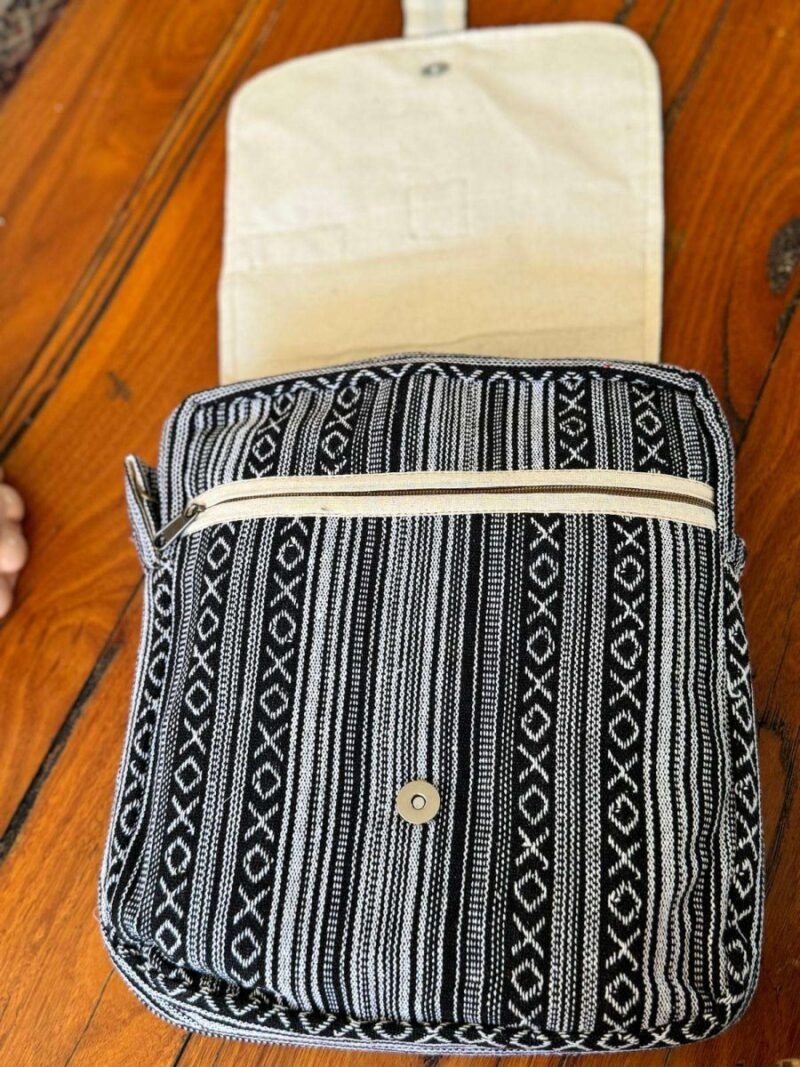 opened flap of black and white hemp side bag
