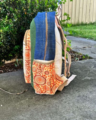 side view of koori backpack with green, blue and orange color
