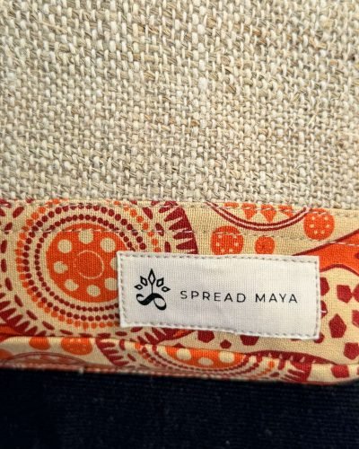 spreadmaya logo in a backpack