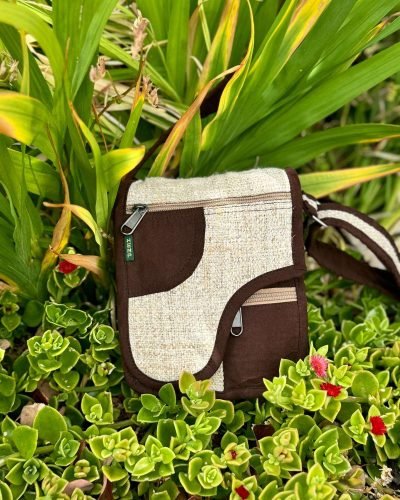 beige and brown flap side bag on grass background