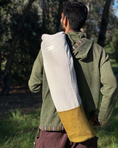 a man carrying half yellow yoga mat cover