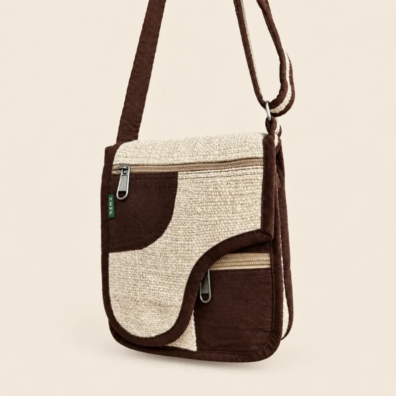 Himalayan earthside hemp crossbody bag with a curved flap and front zip pockets
