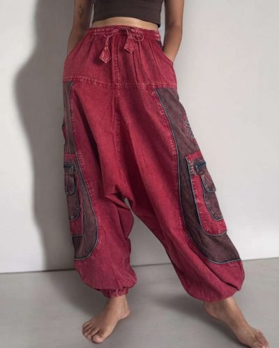 model wearing a Stone washed red baggy cotton trouser, Hand-stitched in Nepal