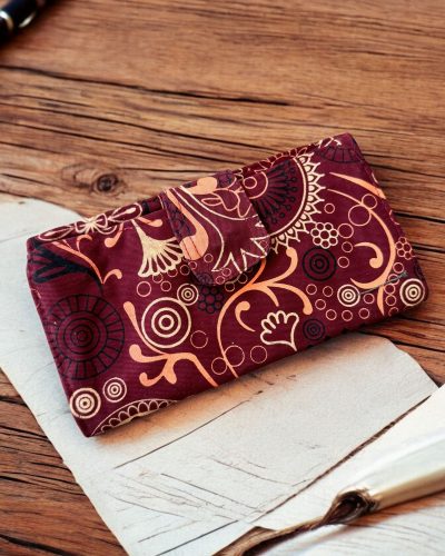 maroon artisan bliss wallet in a table