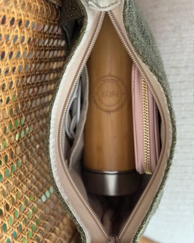 a coffee mug and purse kept in a green hemp side bag