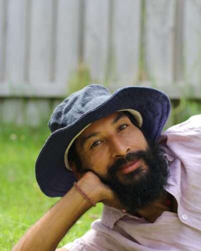 A man wearing navy blue hemp hat