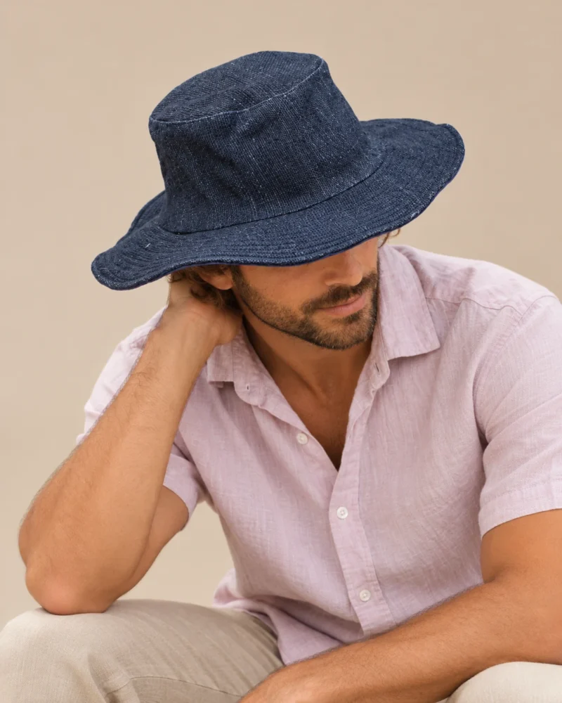 male model looking down wearing KTM safari navy blue hat