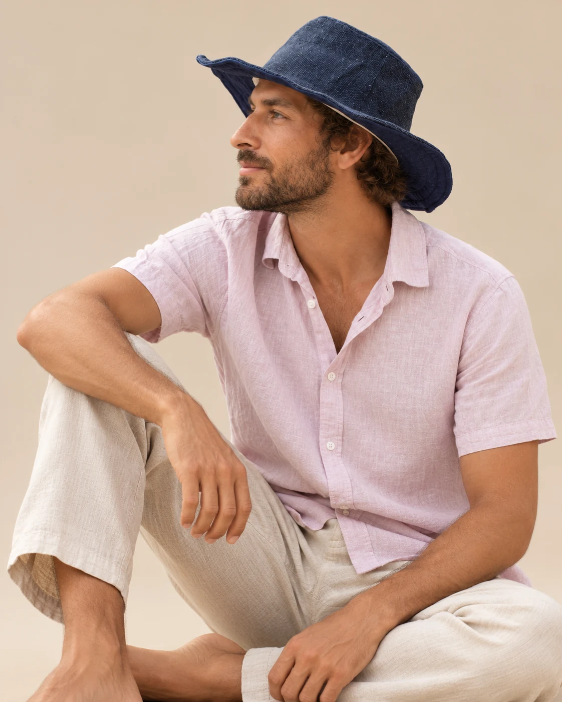 Spreadmaya male model wearing navy blue KTM safari hat and looking sideways