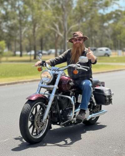 A man posing in bike wearing brown hemp hat