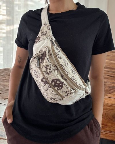 women carrying mushroom printed hemp side bag across shoulder