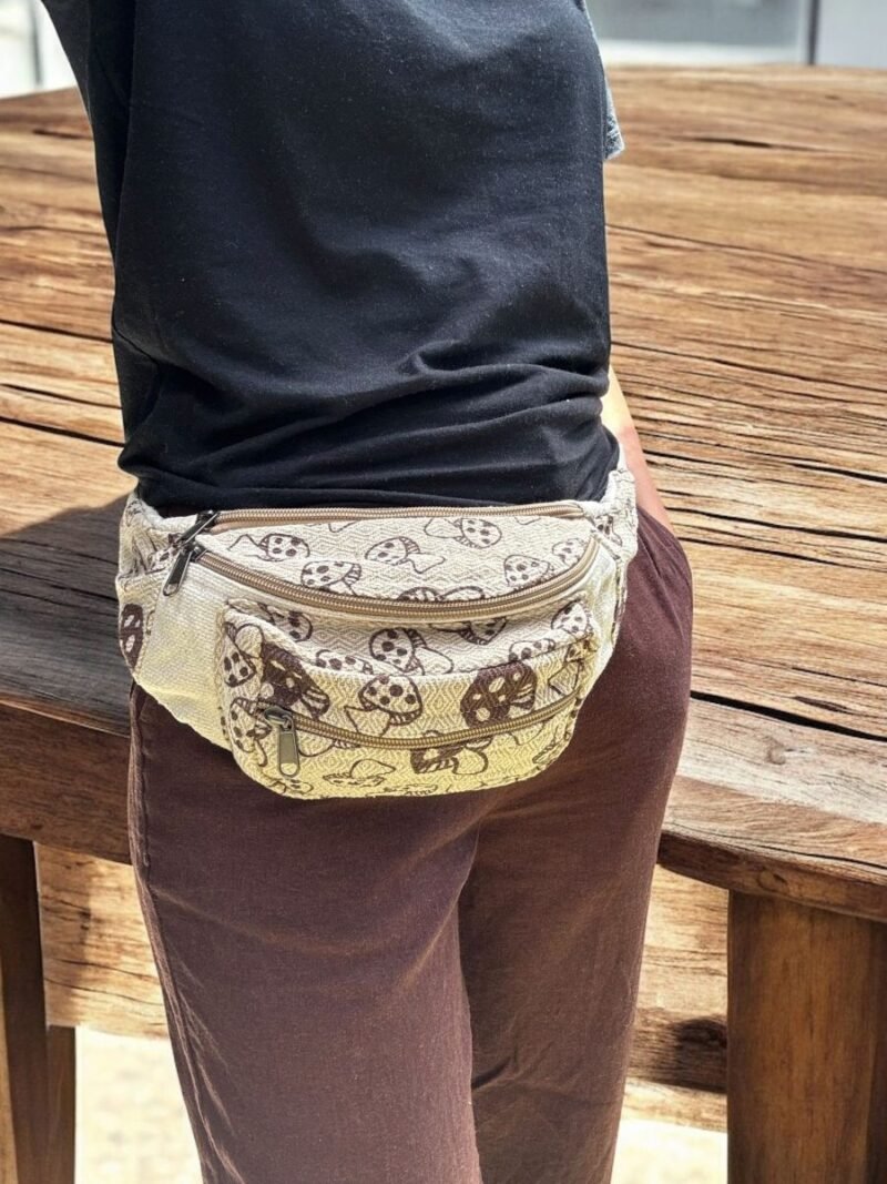 women carrying mushroom printed beige bum bag on hip