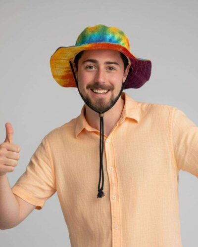 a man posing with rainbow string hemp hat
