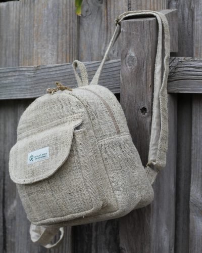 beige hemp mini backpack hang on fence