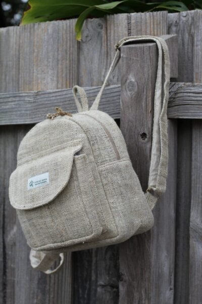 beige hemp mini backpack hang on fence
