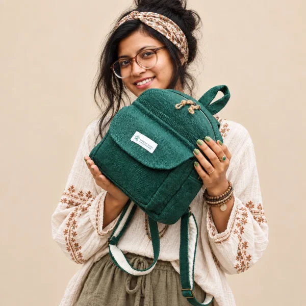 green hemp mini backpack carried by a woman