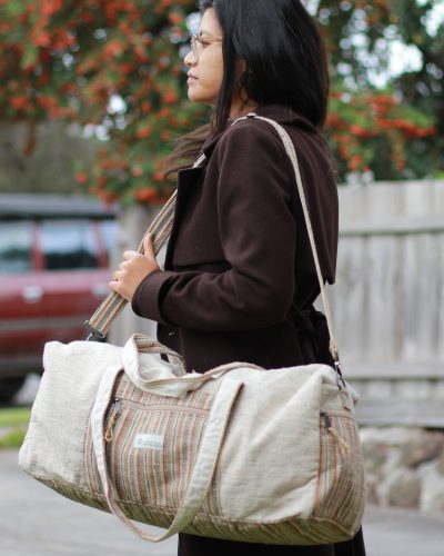 Model carrying Spread Maya's beige hemp duffle bag