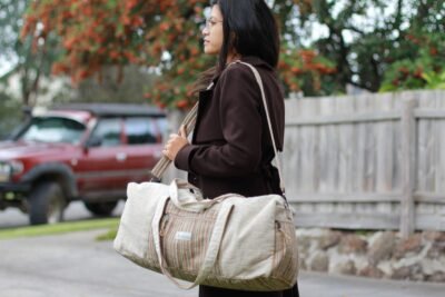Model carrying Spread Maya's beige hemp duffle bag