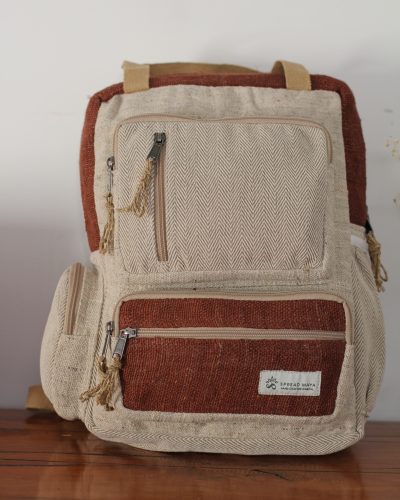 BrownHandmade hemp maternity backpack displayed on a wooden table indoors