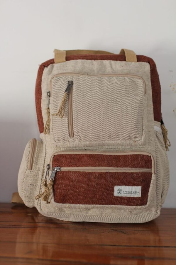 BrownHandmade hemp maternity backpack displayed on a wooden table indoors
