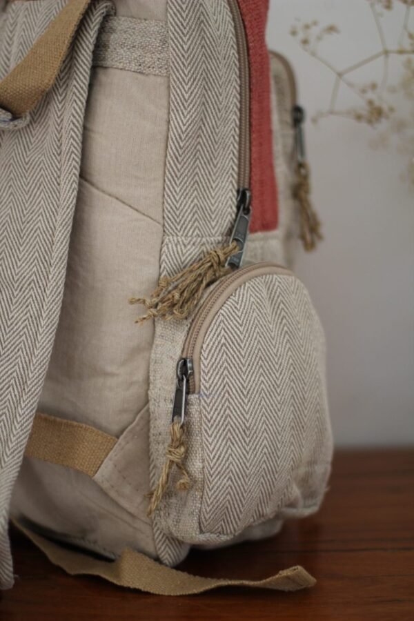 Handmade hemp maternity backpack displayed on a wooden table indoors Side pocket zoom