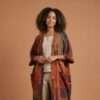 a lady posing simply in an earthy plain background wearing boho soul drape