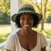 A smiling woman wearing crochet sun hat in natural setting