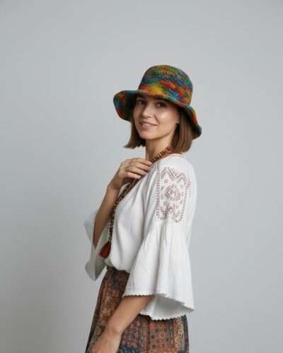 A woman posing in colorful hemp crochet hat in plain background