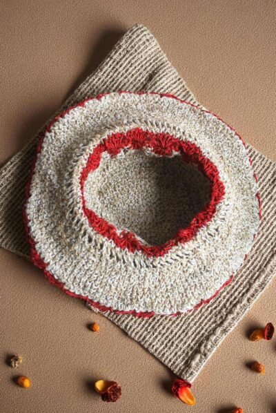 Gurkha looms red crochet hat inside photo on table
