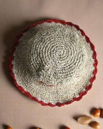 Gurkha looms red crochet hat on table top view