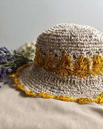 yellow flower Crochet hemp hat on table