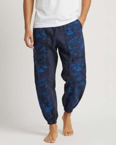 a man posing with mushroom printed trousers