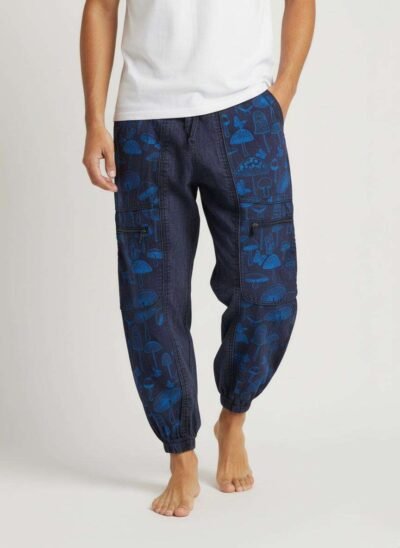 a man posing with mushroom printed trousers