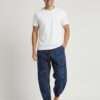 a man posing with mushroom printed blue trousers