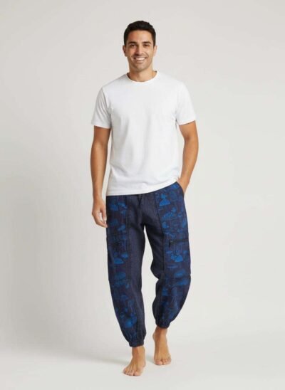 a man posing with mushroom printed blue trousers